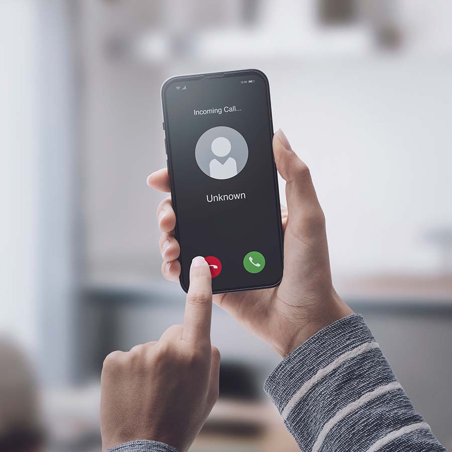 Woman receiving suspicious phone call from unknown number. To avoid the possibility of a scam or phishing attempt, she hits the call cancel button.