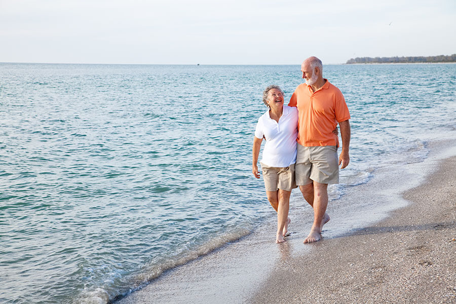 A retired couple on vacation at a tropical island thanks to their freedom credit union personal loan.