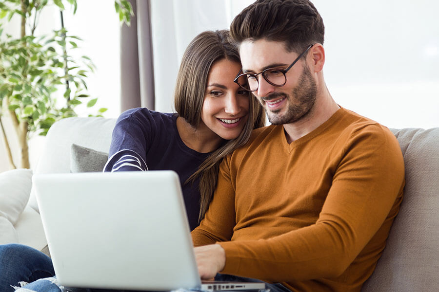 A couple explore secured loans online.